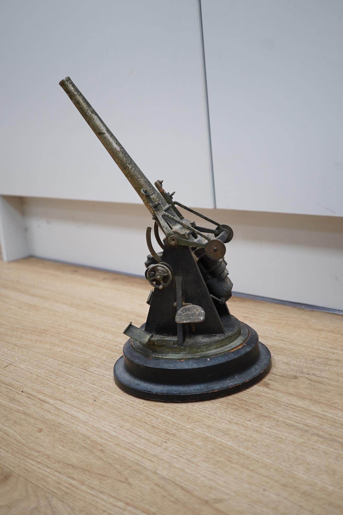 A steel model of a First World War 4 inch mark IX E.O.C. anti-aircraft gun, barrel 18cm, on a turned ebonised pine base with applied label. Condition - fair, some wear overall.